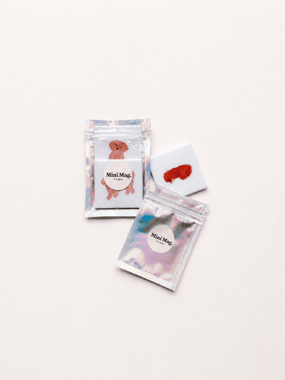 Photo magnets packed in holographic zip pouches sealed with round Mini Mag Studio stickers